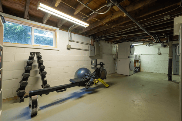 Spacious basement equipped for fitness, featuring ample room for equipment and storage options.
