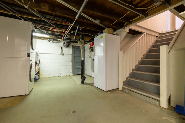 Versatile basement space featuring laundry facilities, ample storage, and easy access to upper floors.