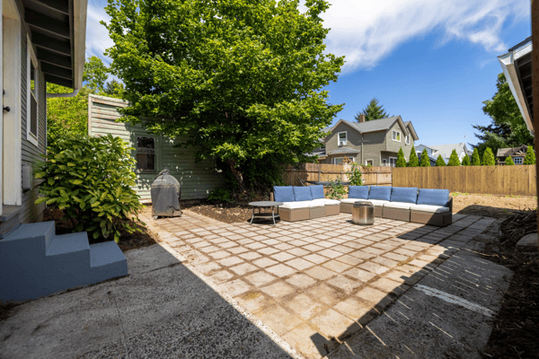 Spacious outdoor patio area with comfortable seating, perfect for entertaining or relaxing in the sun.