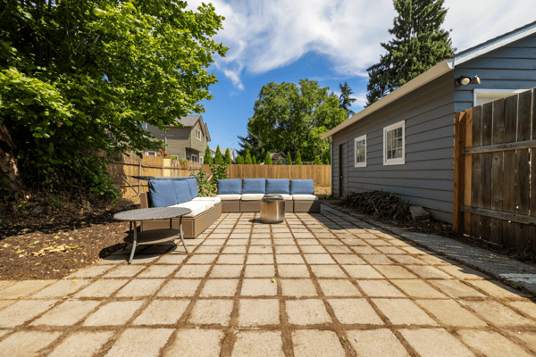 Inviting outdoor space featuring a cozy seating area, perfect for relaxing and entertaining in the sun.