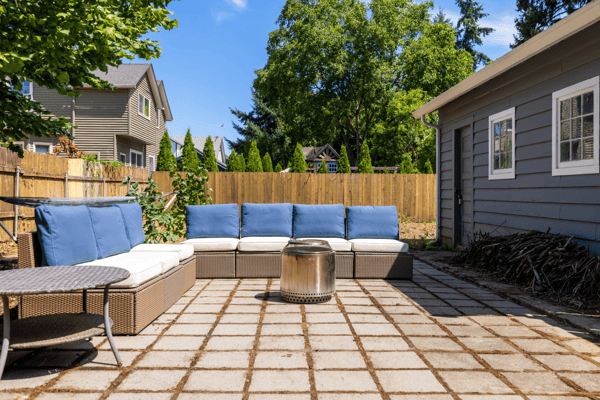 Spacious outdoor patio with comfortable seating and fire pit, perfect for gatherings and relaxation.
