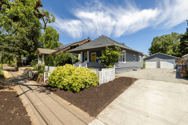 Inviting home featuring updated landscaping, ample parking, and a spacious yard for outdoor activities.