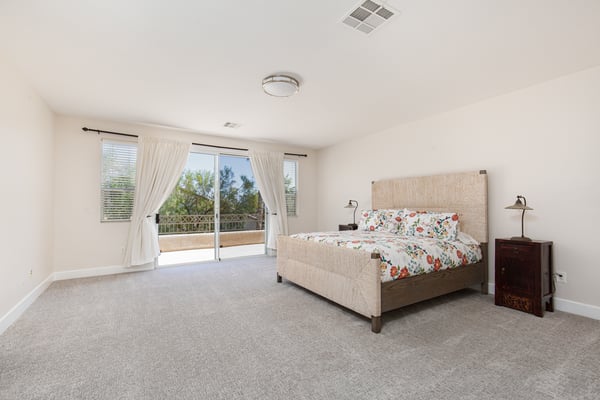 Primary Bedroom with walk-out slider to extended balcony with mountain views
