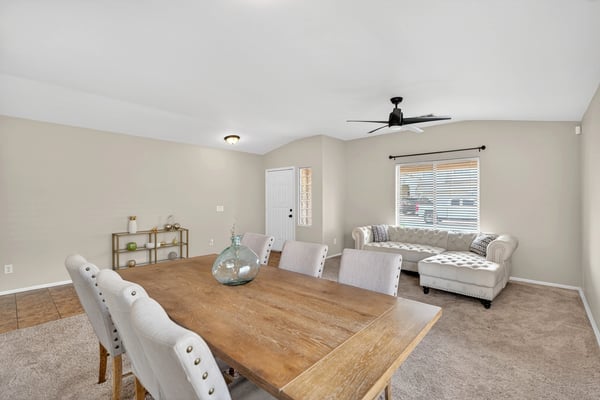 Flexible dining and living area with neutral tones and natural light. Open-concept layout enhances everyday living and entertaining in this Casa Grande home.