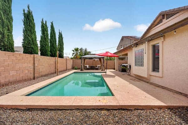 Inviting backyard with pool and low-maintenance design. Perfect for cooling off and entertaining in this Casa Grande home.