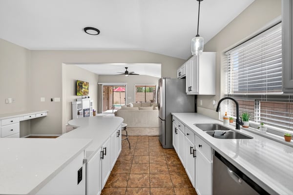 Well-designed kitchen with ample cabinets, stainless appliances, and extended counters. Open flow enhances functionality in this Casa Grande property.