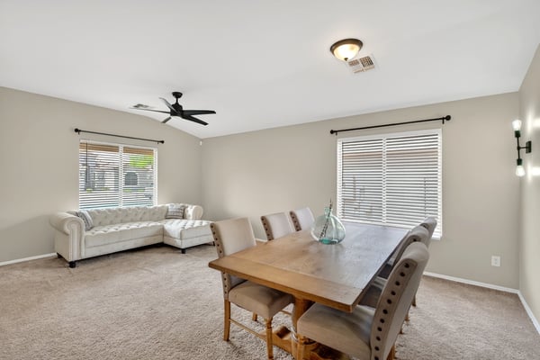 Dining area with large windows and inviting atmosphere. Ideal for gatherings and everyday meals in this Casa Grande home.
