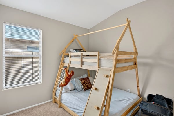 Cozy bedroom with neutral tones and natural light. Perfect for relaxation or guest use in this Casa Grande home.