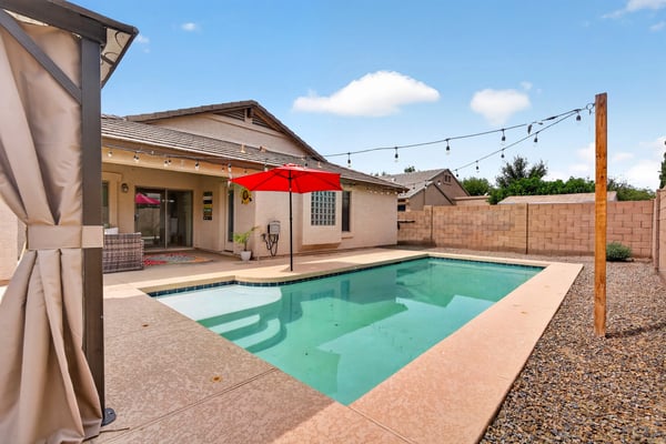 Backyard retreat with pool, patio, and easy-care landscaping. Ideal for relaxing or entertaining in this Casa Grande home.