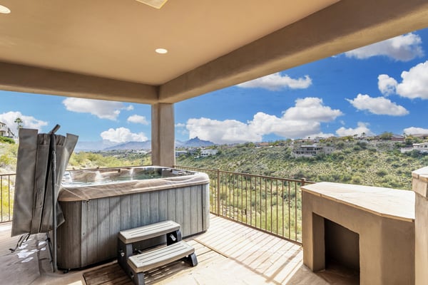 Relax in the private spa while enjoying breathtaking mountain and desert views from this covered outdoor living space. The elevated deck showcases the natural beauty of Fountain Hills and creates a luxurious setting for year-round entertaining and outdoor relaxation.