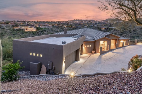 Long driveway and extended garage configuration provide convenience, guest parking, and excellent storage options. The professionally maintained desert landscape complements the home's striking curb appeal.