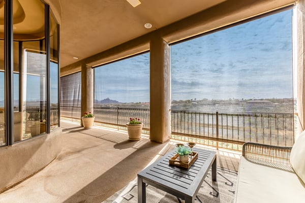 Covered patio equipped with retractable screens for added comfort and sun protection. Designed for effortless outdoor living, this Fountain Hills retreat captures sweeping views while enhancing energy efficiency.