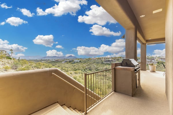 Outdoor entertaining area featuring a built-in grill and expansive views of the surrounding desert landscape. This covered terrace is ideal for hosting gatherings while enjoying Fountain Hills' scenic beauty.