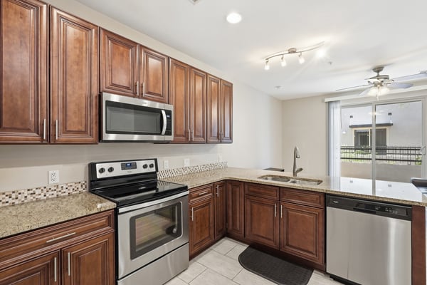 Well-appointed kitchen with granite countertops, stainless steel appliances, rich cabinetry, and generous prep space. Designed for both functionality and style, this kitchen is the heart of the home.