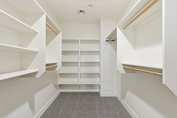 Generously sized walk-in closet with custom shelving and multiple storage options. Perfect for organizing clothing, accessories, and seasonal items.