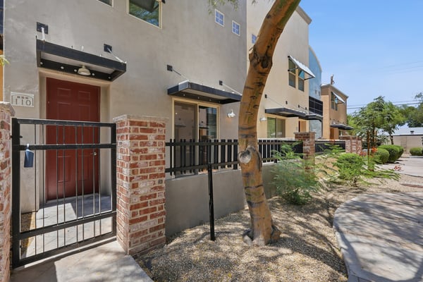 Gated front patio with attractive brick accents and mature landscaping creates a welcoming first impression. An ideal outdoor space for enjoying Arizona's beautiful weather.