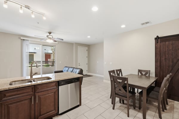 Open living and dining space with tile flooring, recessed lighting, and direct access to the kitchen. The versatile layout supports entertaining, relaxing, and working from home.