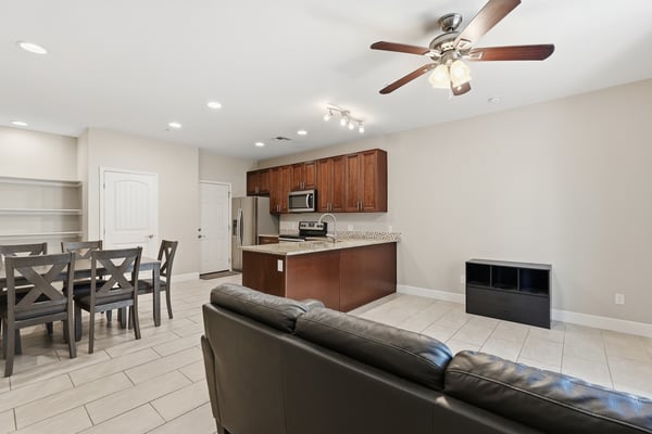 Open living area connected to the kitchen and dining space for effortless entertaining. Recessed lighting and modern finishes create a bright and functional environment.