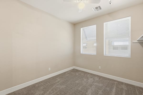 Secondary bedroom offering flexibility for guests, family members, or a home office. Neutral finishes and natural light create a comfortable and welcoming space.