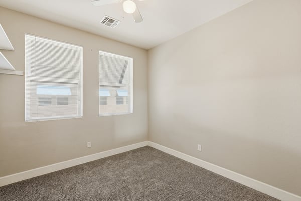 Spacious secondary bedroom with soft carpeting, neutral finishes, and natural light. A flexible room well-suited for guests, remote work, hobbies, or everyday living needs.