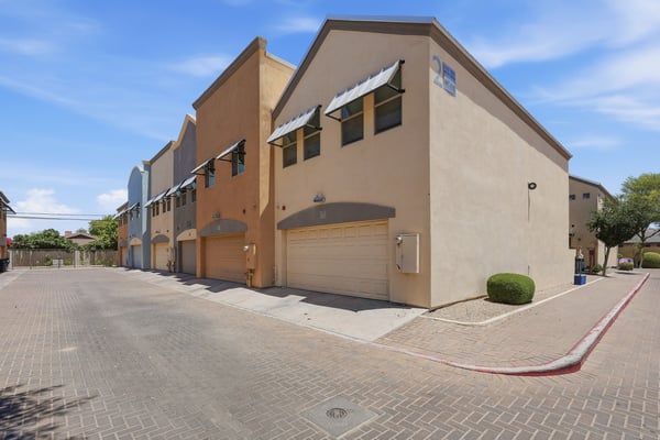 Exterior view highlighting modern townhome architecture, attached garages, and attractive community design. The well-kept setting contributes to the property's move-in-ready appeal.
