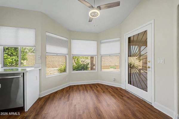 Surrounded by windows and natural light, this inviting breakfast area offers a comfortable setting for morning coffee or casual meals. The direct patio access creates seamless indoor-outdoor living and entertaining opportunities.