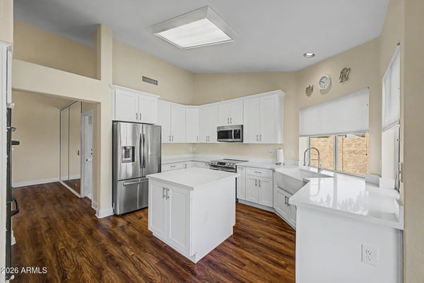 This beautifully maintained kitchen offers extensive cabinetry, modern appliances, durable countertops, and a large workspace island. Natural light and updated finishes make the room both attractive and functional.