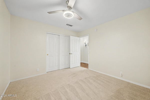 This comfortable bedroom features a ceiling fan, soft carpeting, and generous closet storage. Neutral d cor provides a move-in-ready canvas for a variety of uses and personal styles.