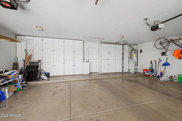 Extensive built-in cabinets and generous vehicle space make this garage ideal for storage, projects, and organization. The thoughtful design adds valuable functionality beyond standard parking space.
