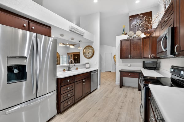 Featuring upgraded cabinetry, solid surface countertops, and stainless steel appliances, this kitchen is designed for both efficiency and style. The open floor plan keeps the space connected to surrounding living areas.