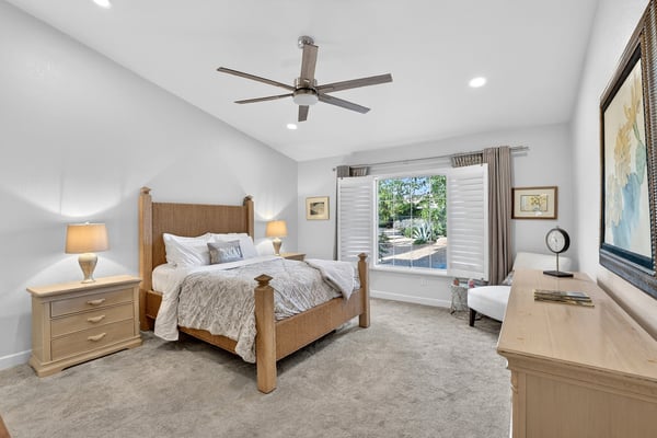 This spacious owner's suite offers a peaceful atmosphere with large windows, soft carpeting, and abundant natural light. The comfortable layout makes it easy to create your perfect private retreat.