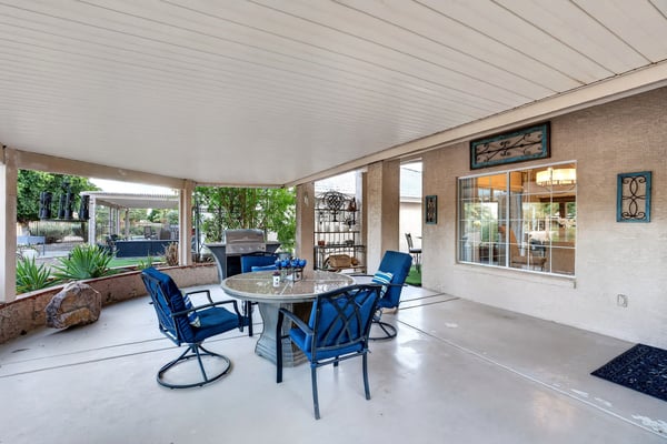 Perfect for outdoor entertaining, this covered patio provides generous space for dining, relaxing, and hosting guests. Backyard views and easy indoor access enhance the experience.