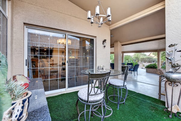 This private patio nook offers a cozy setting for morning coffee or evening relaxation. Convenient access to the home and surrounding landscaping create a tranquil outdoor retreat.