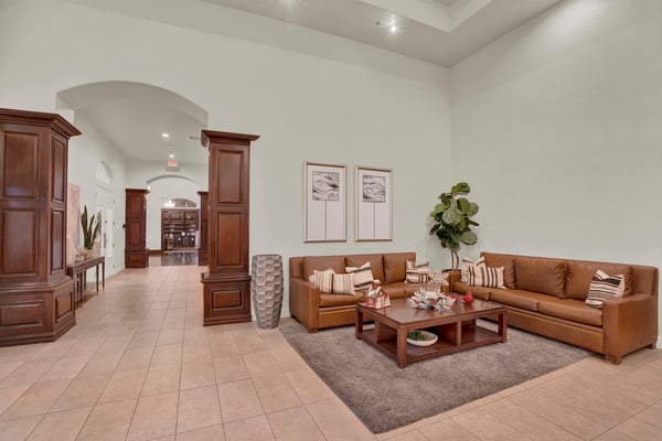 High ceilings, elegant finishes, and comfortable seating make this community lounge a welcoming destination for socializing, relaxing, and participating in neighborhood events.