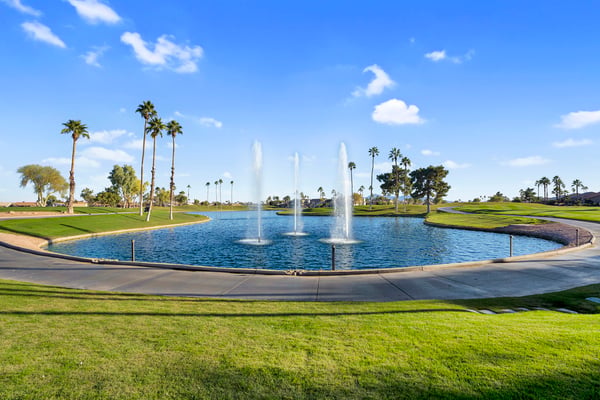 Decorative fountains, sparkling water, and manicured golf course landscapes create a stunning community focal point. This scenic setting enhances the overall appeal of the Goodyear lifestyle.