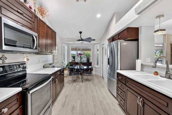 Large windows, updated finishes, and a bright breakfast area make this kitchen a standout feature. The spacious layout offers excellent storage, workspace, and everyday functionality.