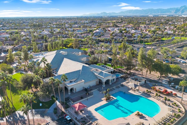 Aerial views showcase the elegant clubhouse, resort-style pool, landscaped grounds, and convenient access to recreational amenities that enhance everyday living in Goodyear.