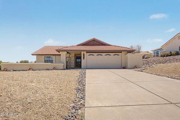 Attractive single-level residence showcasing classic Arizona architecture, a spacious driveway, and low-maintenance desert landscaping. This Fountain Hills property offers beautiful curb appeal and mountain-view surroundings.