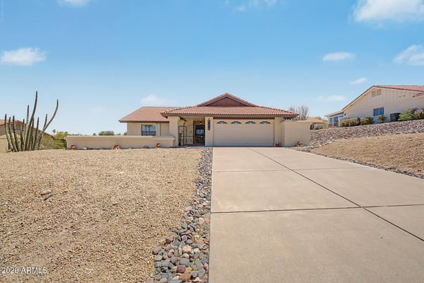 Wide-open views and desert landscaping frame this inviting Fountain Hills home. The expansive front yard and clean exterior presentation create a welcoming first impression for visitors and prospective buyers.