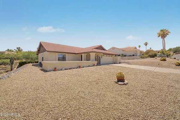 The generous lot and desert landscaping provide a peaceful setting with attractive neighborhood and mountain views. Enjoy the benefits of a low-maintenance property designed for comfortable Arizona living.