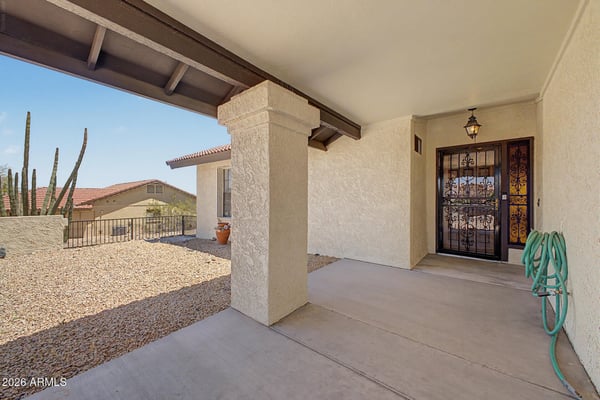 A shaded front porch and decorative gated entry create a warm and inviting arrival experience. This attractive outdoor space adds character while enhancing the home's curb appeal and functionality.