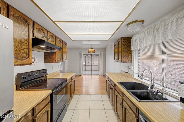 Offering abundant cabinetry and practical workspace, this kitchen provides functionality and convenience. Easy access to adjacent living spaces makes it ideal for everyday meals and gatherings.