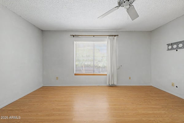 Featuring abundant natural light and attractive flooring, this spacious owner's suite provides a peaceful retreat within the home. The flexible layout allows room for additional seating, workspace, or personalized furnishings.