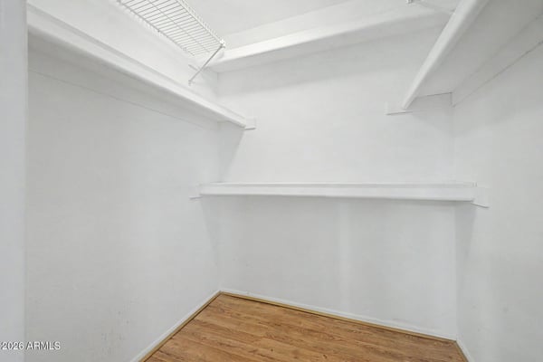A large walk-in closet delivers excellent storage capacity with multiple shelving and hanging areas. This dedicated space helps keep the primary suite organized and clutter-free.