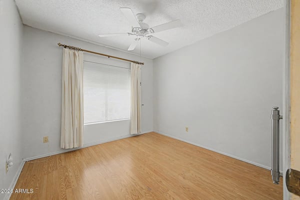 This comfortable bedroom features durable flooring, neutral colors, and excellent natural light. The flexible space can function as a guest room, office, fitness room, or additional sleeping area.