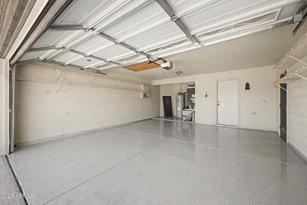 Offering extensive shelving, durable flooring, and generous parking capacity, this garage is designed for organization and convenience. The spacious layout accommodates vehicles, tools, and seasonal storage with ease.