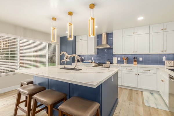Sophisticated kitchen with stainless appliances, quartz countertops, custom cabinetry, and oversized workspace. Updated Scottsdale interiors deliver style, efficiency, and everyday convenience.