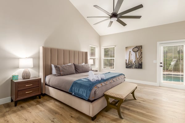 Relaxing primary suite featuring vaulted ceilings, generous dimensions, natural light, and convenient outdoor access. A comfortable Scottsdale sanctuary overlooking the backyard amenities.
