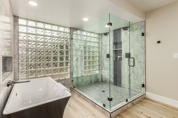 Luxurious primary bathroom featuring a freestanding soaking tub, oversized walk-in shower, custom tile work, and elegant glass accents. A standout Scottsdale retreat with high-end updates throughout.