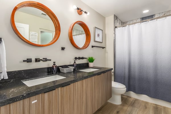 Updated bathroom offering dual sinks, modern cabinetry, stylish mirrors, and quality finishes throughout. A practical and attractive feature of this Scottsdale home.